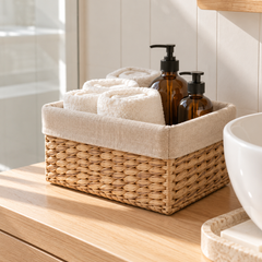Coogee lined seagrass basket holding towels and soap bottles in a bathroom