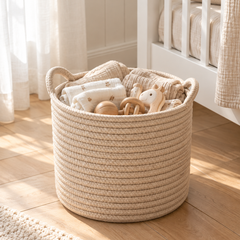 Lorne cotton rope basket holding baby blankets and toys in a nursery